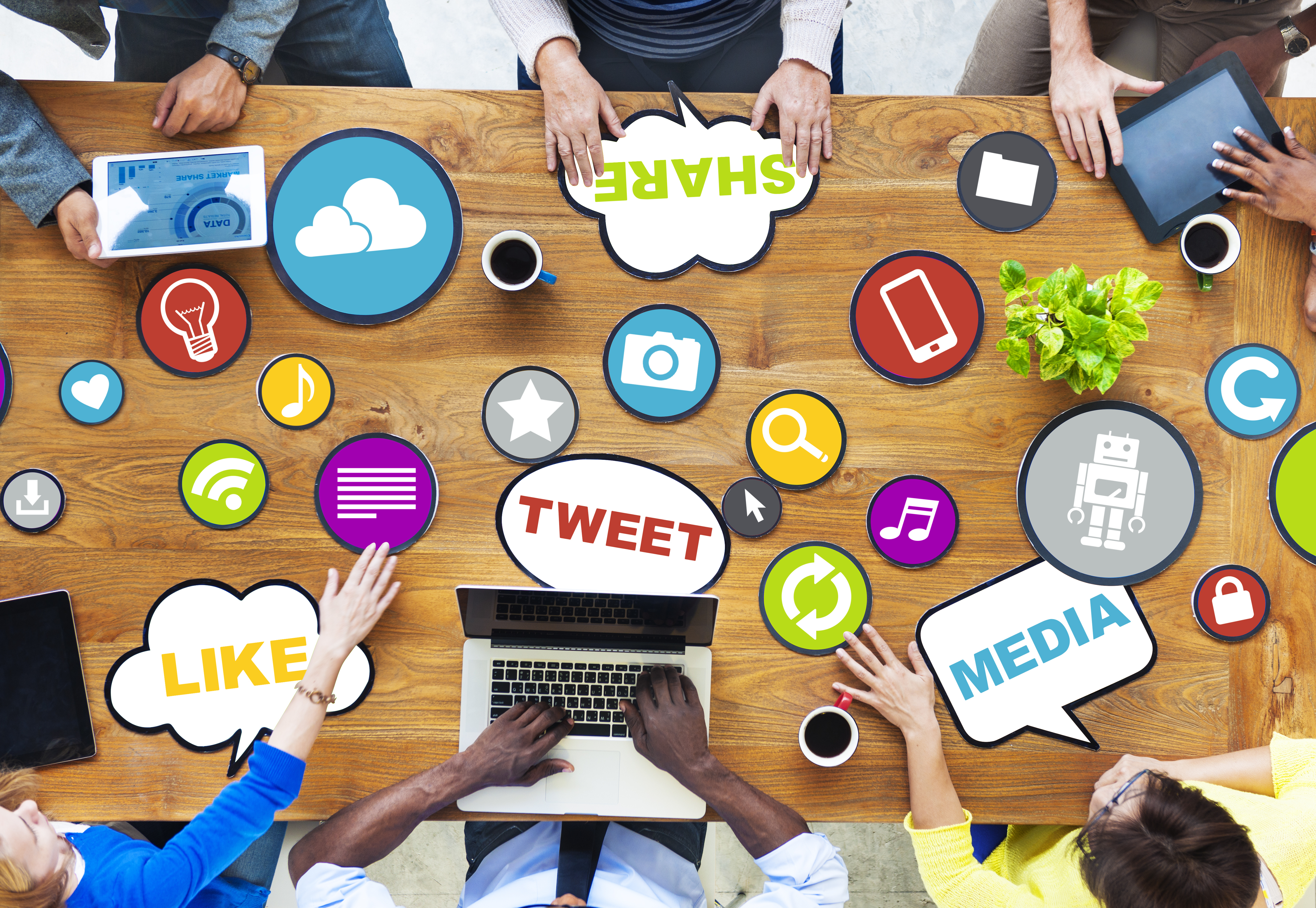 Top view of a meeting table with icons of social medias